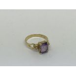 A 14ct gold ring set with an amethyst and 2 small