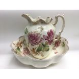 A Victorian wash bowl and jug decorated with roses