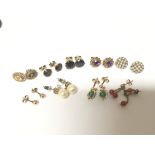 A collection of gold earrings set with seed Pearl