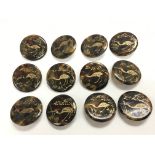 Twelve tortoiseshell buttons decorated with a stor