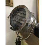 An old theatre stage light raised on a folding sta
