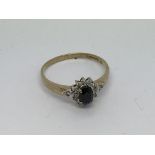 A 9ct gold ring set with a sapphire and diamond cl