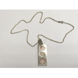 An unusual silver pendant and chain by Tego & Co.