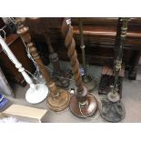7Decorative standard lamps Including wooden and brass examples.