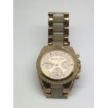 A Michael Kors gold tone ladies watch with subsidi