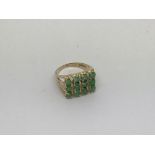 A 9ct gold ring set with 12 emeralds. Size k appro