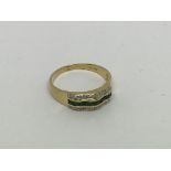 An 18ct gold ring set with emerald and diamond clu