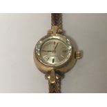 A Ladies 9carat gold omega watch with gold bracele