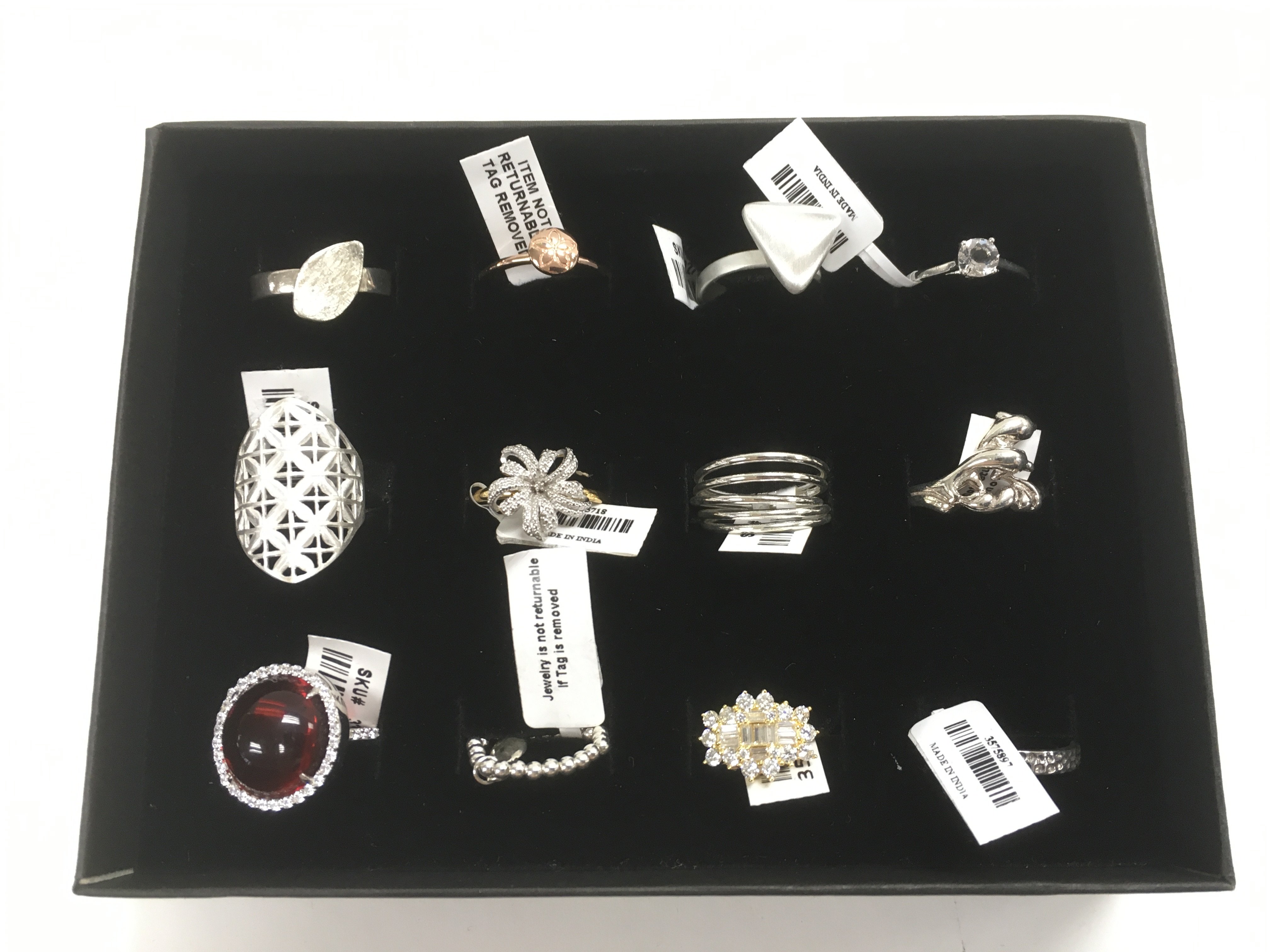 A collection of 12 new silver rings.