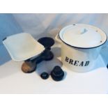 A box containing an enamelled bread bin, kitchen scales and a small collection of good brass ware.