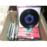 A box of 7 inch singles by various artists from th