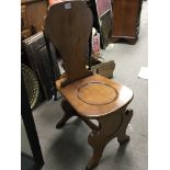 A continental late 19th century Elm hall chair wit