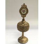 An unusual gilt metal perfume bottle with lift up