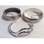 Three H/M silver bracelets.