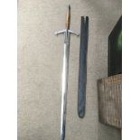 A large replica claymore sword and two other repli
