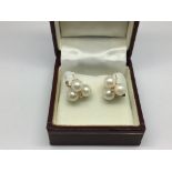 A pair of 14ct, pearl and diamond earrings, approx