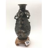 A late Chinese bronze vase with overlaid grape and