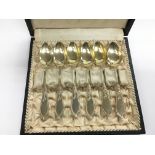 A cased set of silver tea spoons with silver gilt