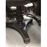 A Victorian rosewood circular dining table on a fl