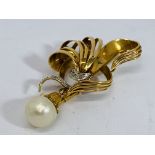 A pretty unmarked gold brooch set with diamonds an