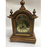 An 8 day oak cased mantle clock with arched top ab