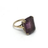 A 9ct gold ring set with an amethyst coloured ston