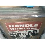 A bag of LPs and 12 inch singles by various artists including The Travelin Wilburys, Curved Air, OMD