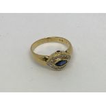 An 18ct gold ring set with marquis sapphire and di