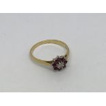 An 18ct gold ring set with Ruby’s and diamond. Siz