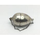 An antique silver egg shaped sewing etui.
