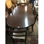 A regency style mahogany dining table with 6 sabre leg dined chairs (4+2 carvers)
