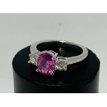 An 18ct white gold oval cut pink sapphire and diam