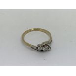An 18ct gold and platinum ring set with 3 diamonds