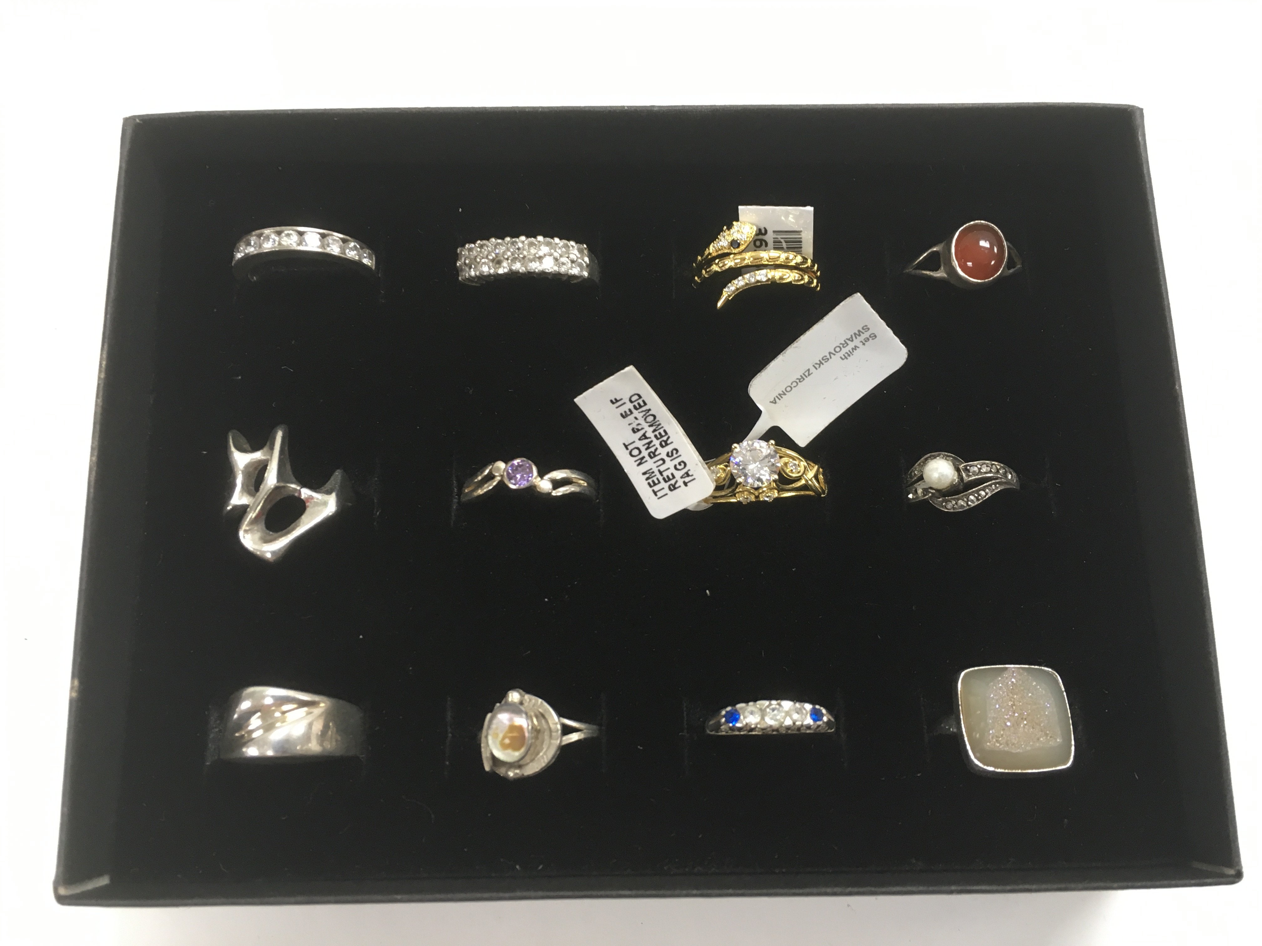 A collection of 12 silver rings, some new.