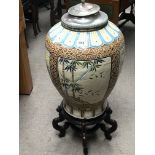 A large 20th century oriental vase on a hardwood stand.