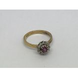 An 18ct gold ring set with a ruby and diamond clus