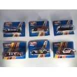 Six Hot Wheels Super toy cars. A Lancia 037 turbo,