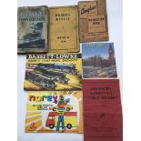 A collection of car hand books, toy catalogues etc