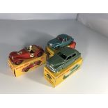 Three Dinky Toys model cars. An M.G. Midget Sports