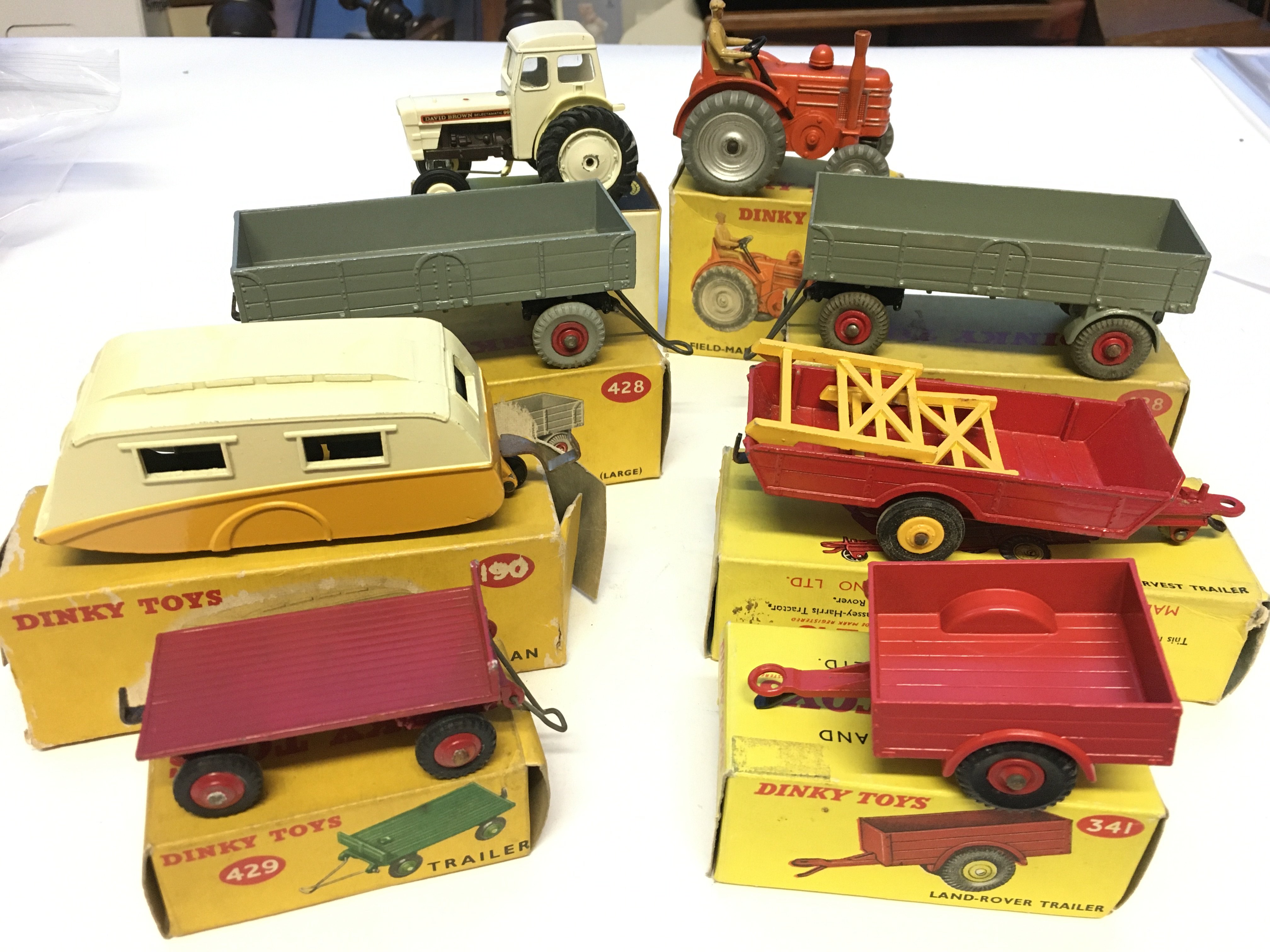 A Dinky Caravan #190,a Land-Rover Trailer #341, a Trailer #429, a Harvest Trailer #320, 2 x Trailer