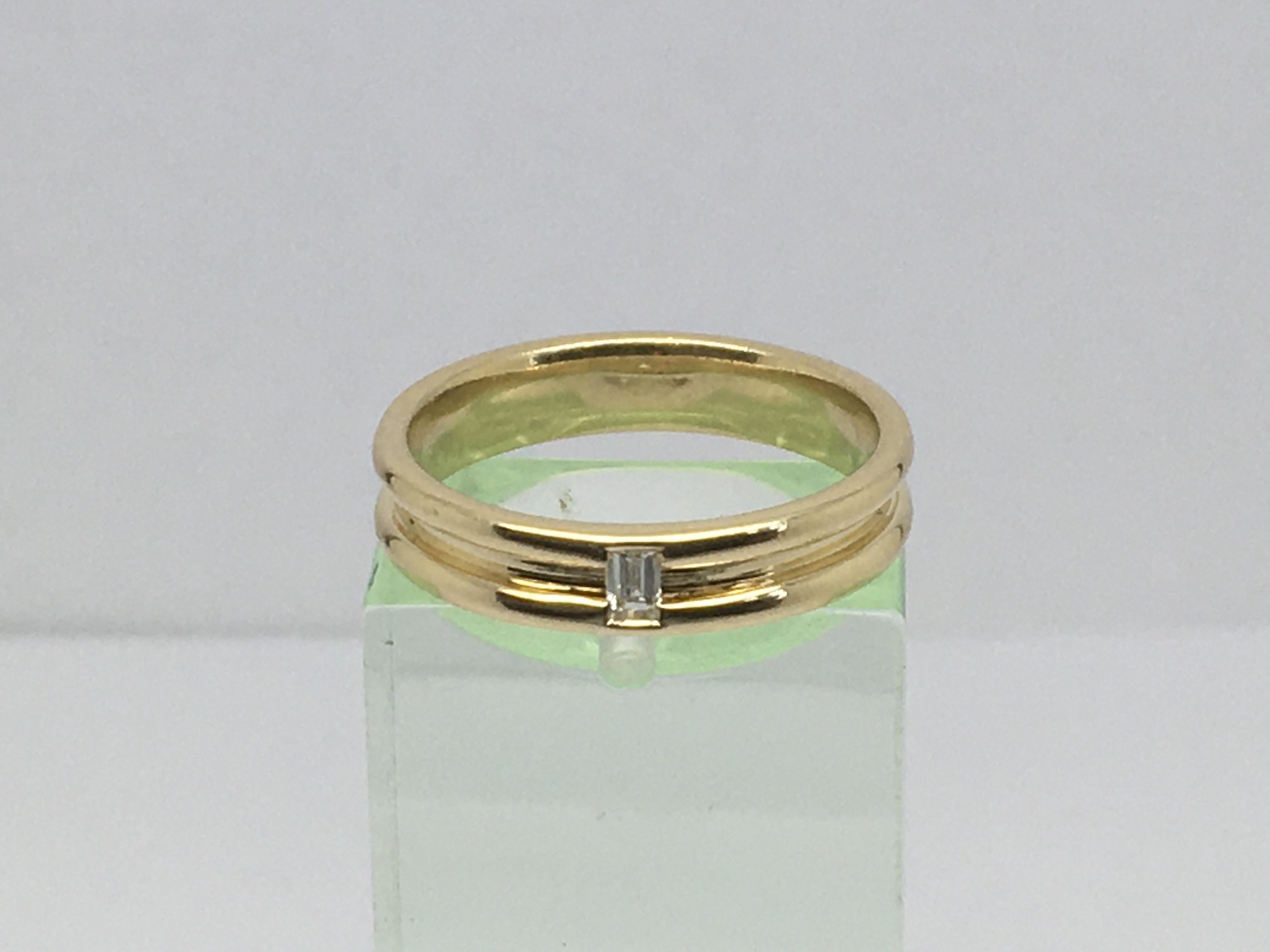 A 9ct gold wide band ring set with an eight point solitaire diamond, approx 4.3g and approx size N.