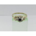 An 18ct gold ring set with a central sapphire and diamonds, approx .12ct, approx 2.9g and approx
