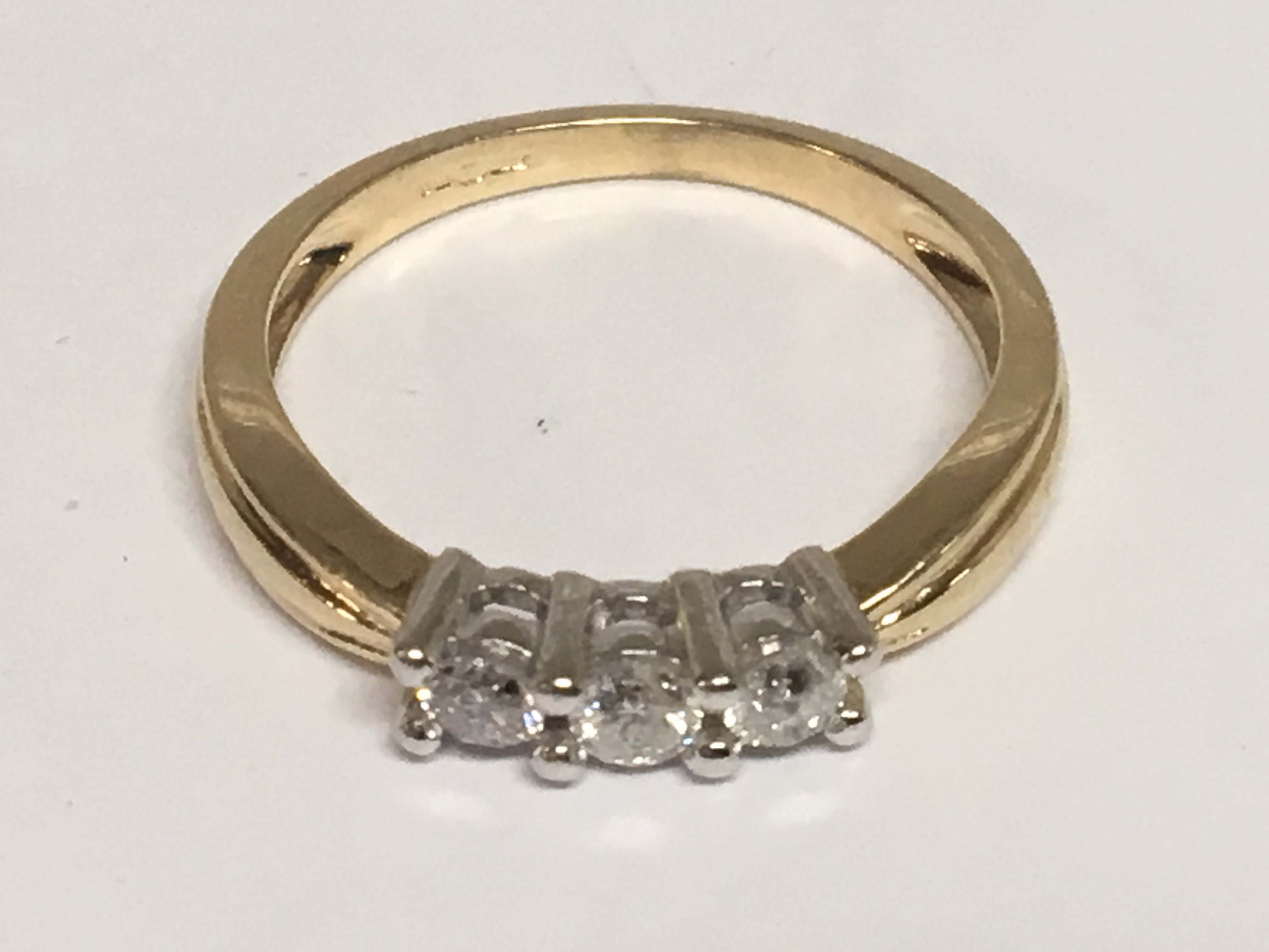 An 18carat gold ring set with three rose cut diamonds. Ring size O.