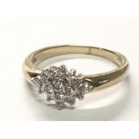A 9carat gold ring set with a pattern of sixteen brilliant cut diamonds.ring size P.