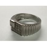 A Gents white gold ring set with a pattern of diamonds. Ring size U.