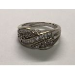 A 9carat white gold ring set with alternating rows of baguette and brilliant cut diamonds ring