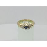 An 18ct gold ring set with a central sapphire surrounded by diamonds, approx 1/2 ct, approx 5.2g and