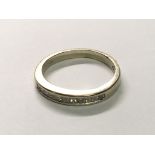 An 18carat gold half hoop eternity ring set with princess cut diamonds. Ring size I
