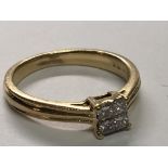 An 18carat gold ring set with a square pattern of Princess cut diamonds approximately 0.25 of a