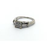 An 18ct white gold ring set with nine princess cut diamonds, approx 4.5g and approx size K-L.